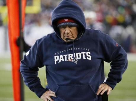 New England Patriots head coach Bill Belichick walks along the sideline in the first half of an NFL divisional playoff football game against the Baltimore Ravens Saturday, Jan. 10, 2015, in Foxborough, Mass. (AP Photo/Elise Amendola)
