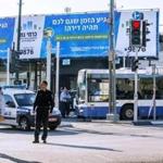 Israeli police officers stood near the scene of an attack after a Palestinian man stabbed at least five people on a Tel Aviv bus.
