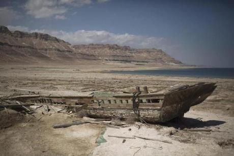 An abandoned tourist Boat shipwreck lying at the Dead Sea coastal resort near Ein Gedi, Israel. 
