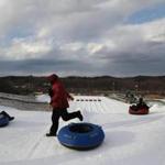 Tubers prepare for a ride at the New England Sports Park, which opened this month, a year after the previous owners filed for bankruptcy.