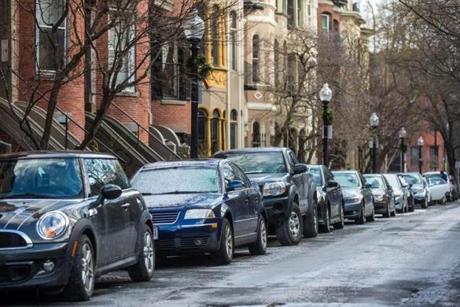 The city currently offers residents a free parking pass for every vehicle they own, despite a limited number of spots. Pictured: Cars parked on Rutland Square in Boston. 

