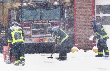 Firefighters worked to clear the front of a station in downtown Boston.

