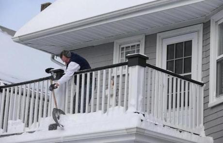 A Dorchester resident cleared snow off his upper deck.
