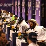 Seattle Seahawks defensive end Michael Bennett and other teammates answer questions during the NFL Super Bowl media day, Tuesday, Jan. 27, 2015 in Phoenix. (AP Photo/Doug Benc)