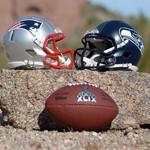 Jan 28, 2015; Tempe, AZ, USA; General view of Seattle Seahawks and New England Patriots helmets and Super XLIX logo football at Papago Park. Mandatory Credit: Kirby Lee-USA TODAY Sports