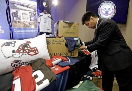 Homeland Security agent Gabriel Gonzalez displayed counterfeit goods at a news conference for the NFL Super Bowl XLIX game.
