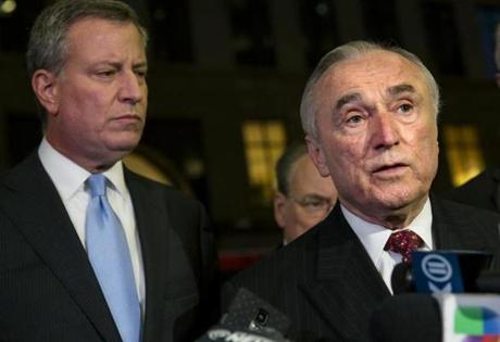 New York Police Commissioner William Bratton (right), with Mayor Bill de Blasio, wants to give officers more time to engage with the community.
