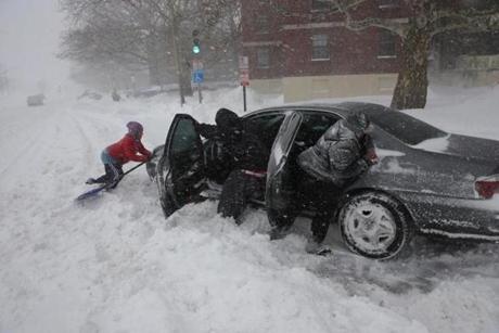 (From left to right) Shirley Jean, Mike Jackson and his wife Cay Jackson attempted to move their stuck car in South Boston.
