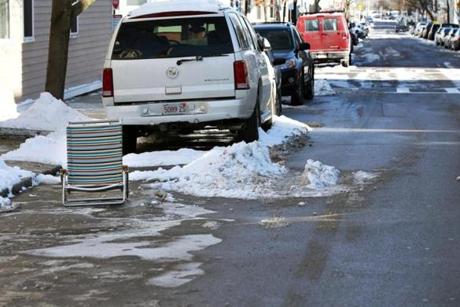 Residents across Boston use an array of items as parking savers after a snowstorm
