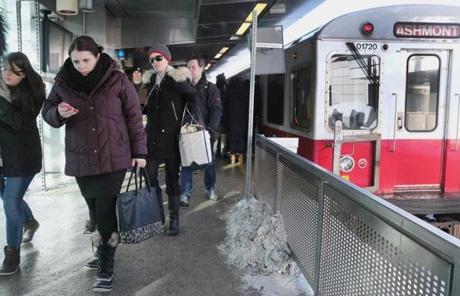 Commuters disembarked a train on the Red Line at the Charles/MGH station.
