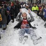 A fan has fun in the snow as the Patriots make their way down Boylston Street. 