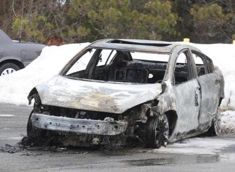 A burned-out car was towed from the crime scene in Bourne.
