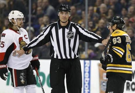 Brad Marchand (right) likes to get under the skin of opponents, but he rarely drops the gloves to fight.

