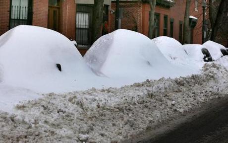 Vehicles on Chandler Street in Boston?s South End remained buried in snow Friday.
