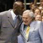 Former University of North Carolina player and NBA standout Michael Jordan (L) kisses former University of North Carolina head coach Dean Smith during a ceremony honoring the 1957 and 1982 national championship teams at halftime of the NCAA basketball game between North Carolina and Wake Forest University in Chapel Hill, North Carolina, in this file photo taken February 10, 2007. Smith, a legendary head basketball coach at the University of North Carolina whose proteges include NBA great Michael Jordan, has died at age 83, the university reported on its website on Sunday. REUTERS/Ellen Ozier/Files (UNITED STATES - Tags: SPORT BASKETBALL OBITUARY)