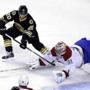 Boston Bruins left wing Daniel Paille (20) and Montreal Canadiens goalie Carey Price (31), vie for control of the puck during the first period of an NHL hockey game, Sunday, Feb. 8, 2015, in Boston. (AP Photo/Steven Senne)