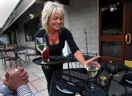 Janice Santarpio served pre-dinner wine to a table outside Rosaria's Steakhouse in Saugus last summer.
