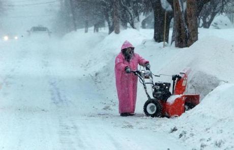 The operator of a snow blower in North Andover worked to clear snow.
