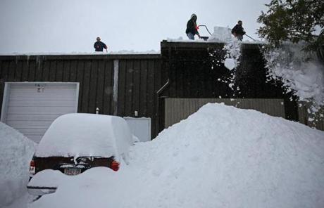 Workers shoveled the roof of another building on Weymouth Street in Rockland.
