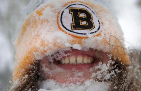 Ale Mineo-Levitsky, 10, was all smiles after plopping face first into a snowbank in Brookline.
