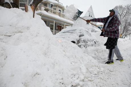 Large snowbanks flanked a Dorchester resident as he worked to dig out his car.
