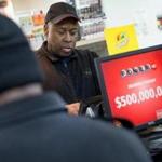Kirk Cook printed a Powerball lottery ticket for a customer at a 7-Eleven store in Chicago on Wednesday.