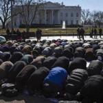 A group of demonstrators prayed Friday outside the White House after three Muslim students were shot to death in North Carolina this week.