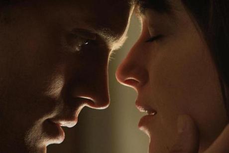 Jamie Dornan as Christian Grey (left) and Dakota Johnson as Anastasia Steele in ?Fifty Shades of Grey.?
