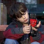 Ethan Brown, 8, adjusted his Cyborg Beast hand. Materials for a prosthetic hand made on a 3-D-printer can cost as little as $20 to $50. Some specialists say they work just as well, if not better, than devices that cost much more.