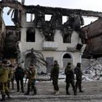 Armed pro-Russia rebels gathered near a partially collapsed building in Uglegorsk, Ukraine, about four miles from the seized town of Debaltseve.