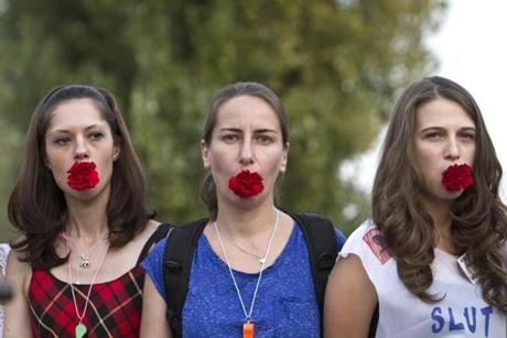Protesters in Romania held carnations in their mouths during a 2011 protest against harassment of women initiated over their public appearance or behavior. 
