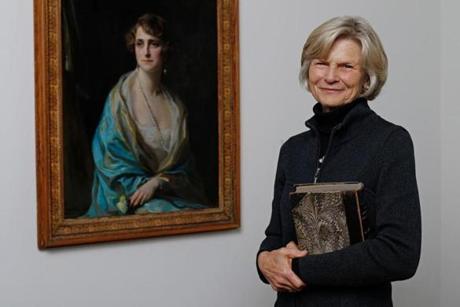 MFA trustee Bettina Burr stands next to a painting of her grandmother, Baroness Clarice de Rothschild, by the artist Philip de László. The piece is part of a collection being donated to the MFA
