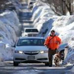 Snowbanks in South Boston made navigating roads difficult for both pedestrians and vehicles.