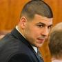 Aaron Hernandez looked at his attorney as security footage was shown on a monitor during his murder trial.