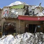 Afghan men removed snow from the roof of a damaged house after avalanches in Panjshir province.