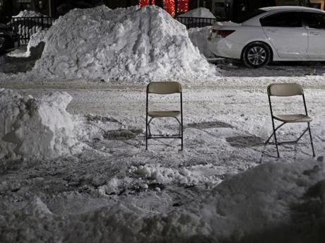 Many Bostonians say they plan to keep their savers right where they are. Pictured: Chairs were used as space savers in the South End this winter.
