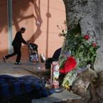 Flowers and candles were placed on a sidewalk near where a man was shot and killed by police in the Skid Row section of downtown Los Angeles.