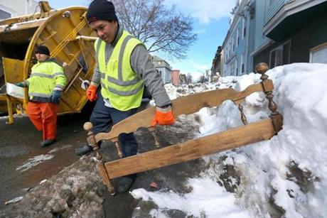 A bed headboard that was used as a space saver was carried off by Vladimir Diaz in East Boston. 
