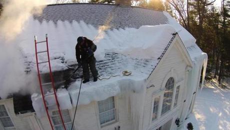 In this image taken by a drone, Jesus Foentes of Ice Dam Liquidators used steam to clear the roof of this Carlisle home. 
