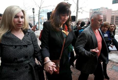Marathon bombing survivors Heather Abbott (left) and Karen Rand McWatters, with hus-band Kevin McWatters, exited court together Wednesday after the trial?s first session. 
