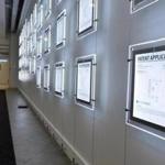A wall of illuminated patent applications lines a corridor at EnerNoc?s One Marina Park Drive headquarters.