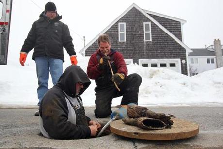  (From left) Justin Craig of the city of Newburyport and Matt Nard and Bart Sanders, both contractors from Indiana, worked last week to restore sewage service to Plum Island. The city has spent $250,000 supplying housing for residents and for fixing the system. Officials are angry about the failure because the sewage system is only several years old.
