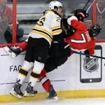 Ottawa Senators' Kyle Turris, right, gets slammed into the boards by Boston Bruins' Chris Kelly during first period NHL hockey action in Ottawa, Ontario, on Tuesday, March 10, 2015. (AP Photo/The Canadian Press, Sean Kilpatrick)