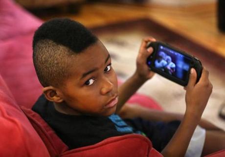 Tafari Amais Edge-Wallace, 10, says he would rather play a baseball video game than watch a real one. ?Watching is boring,? he said.
