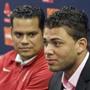 Boston Red Sox director of international scouting Eddie Romero (L) listens as Cuban baseball player Yoan Moncada speaks to reporters at the Boston Red Sox training complex in Fort Myers, Florida March 13, 2015. Moncada and the Red Sox announced a record $31.5 million deal after he passed a pending physical, according to team officials on Friday. REUTERS/Steve Nesius (UNITED STATES - Tags: SPORT BASEBALL)
