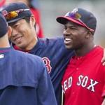 Fort Myers, Fl-Feb. 28, 2015 2015--Globe Staff photo by Stan Grossfeld--Japanese Sox pitcher Koji Uehara and Cuban outfielder Rusney Castillo bond prior to a workout at JetBlue Park.