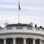 Uniformed Secret Service agents patrolled the top of the White House as seen from the South Lawn.