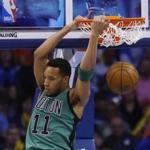 Boston Celtics guard Evan Turner (11) dunks in the first quarter of an NBA basketball game against the Oklahoma City Thunder in Oklahoma City, Wednesday, March 18, 2015. (AP Photo/Sue Ogrocki)