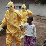 A 9-year-old was escorted to an ambulance after showing signs of Ebola in a Liberian village.