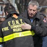 New York Mayor Bill de Blasio consoled Fire Commissioner Daniel A. Nigro after arriving Saturday at the site of a home fire in Brooklyn that killed seven children. 